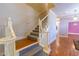 Foyer staircase with decorative spindles, hardwood flooring and natural light at 115 Flagstop Run, Fayetteville, GA 30215