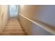Carpeted stairwell featuring a white handrail at 115 Flagstop Run, Fayetteville, GA 30215
