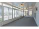 Spacious sunroom enclosed with multiple windows for a beautiful view of the backyard at 115 Flagstop Run, Fayetteville, GA 30215
