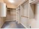 Walk-in closet with ample shelving and clothing rods, providing optimal organization and storage at 115 Flagstop Run, Fayetteville, GA 30215