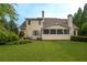 Expansive backyard featuring a well-manicured lawn, patio seating, and screened-in porch, ideal for outdoor living at 2403 Wistful Way, Marietta, GA 30066