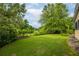 Spacious, green backyard area with mature trees and manicured landscaping providing a serene outdoor setting at 2403 Wistful Way, Marietta, GA 30066