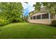 Lush backyard with a screened-in porch, patio seating, and ample green space perfect for outdoor activities at 2403 Wistful Way, Marietta, GA 30066