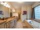 Bright bathroom with double sink vanity, soaking tub, and decorative window at 2403 Wistful Way, Marietta, GA 30066