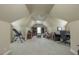 Spacious bonus room features a ceiling fan, neutral carpet, and a cozy sitting area and office set up at 2403 Wistful Way, Marietta, GA 30066