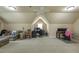Large bonus room features neutral walls, carpet, and ceiling fan, offering a versatile space for various activities at 2403 Wistful Way, Marietta, GA 30066