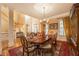 Formal dining room featuring a large wood table, elegant chandelier, and access to other living areas at 2403 Wistful Way, Marietta, GA 30066