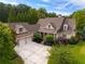 Expansive home showcasing a three-car garage, complemented by lush landscaping, and a spacious driveway at 2403 Wistful Way, Marietta, GA 30066