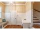 Traditional foyer features hardwood floors, wainscoting, built-in bench, and staircase at 2403 Wistful Way, Marietta, GA 30066