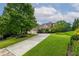 Beautiful home with lush front yard, mature trees, and a long driveway leading to a three-car garage at 2403 Wistful Way, Marietta, GA 30066