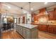 Open kitchen with granite countertops, custom cabinets and stainless appliances with views into the living area at 2403 Wistful Way, Marietta, GA 30066