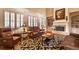 Bright living room featuring a fireplace, built-in shelves, large windows, and leather furniture at 2403 Wistful Way, Marietta, GA 30066