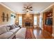 Cozy living room with stone fireplace, ceiling fan, and hardwood floors for comfortable living at 2403 Wistful Way, Marietta, GA 30066