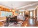 Open-concept living room and dining area with stone fireplace and hardwood floors, perfect for entertaining at 2403 Wistful Way, Marietta, GA 30066