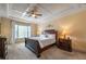 Spacious main bedroom with tray ceiling, carpet floors, and ensuite bathroom at 2403 Wistful Way, Marietta, GA 30066