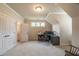 Neutral office with built-in desk, bright lighting, closet, and view to a bathroom at 2403 Wistful Way, Marietta, GA 30066
