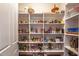 Organized pantry with shelving stocked with canned goods, snacks, and other non-perishable items at 2403 Wistful Way, Marietta, GA 30066