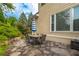 Stone patio with outdoor dining set, surrounded by lush landscaping, offering a relaxing outdoor space at 2403 Wistful Way, Marietta, GA 30066