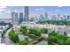 Scenic aerial view of neighborhood with pond, bridge, and the cityscape in the backdrop at 390 17Th Nw St # 2053, Atlanta, GA 30363