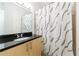 This bathroom features a granite vanity and a shower with patterned shower curtain at 390 17Th Nw St # 2053, Atlanta, GA 30363