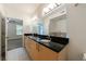 Bathroom features dual sink vanity, black countertop and modern fixtures at 390 17Th Nw St # 2053, Atlanta, GA 30363