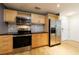 This bright kitchen is equipped with sleek stainless steel appliances, wooden cabinets, and stylish tiled backsplash at 390 17Th Nw St # 2053, Atlanta, GA 30363