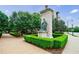 Beautiful landscaping featuring manicured hedges, mature trees, and stone monument in residential neighborhood at 390 17Th Nw St # 2053, Atlanta, GA 30363