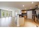 Bright living room with wood floors, ceiling fan, and access to a balcony at 390 17Th Nw St # 2053, Atlanta, GA 30363