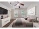 Bedroom featuring neutral decor, a ceiling fan, and sunlit windows with outdoor views at 390 17Th Nw St # 2053, Atlanta, GA 30363