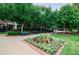 Inviting park area with benches, flower beds, mature trees, and lush greenery in a tranquil setting at 390 17Th Nw St # 2053, Atlanta, GA 30363