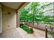 Exterior patio view overlooks green trees and bushes with a metal fence at 390 17Th Nw St # 2053, Atlanta, GA 30363