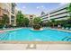 Community pool with lounge chairs and umbrellas at 390 17Th Nw St # 2053, Atlanta, GA 30363