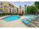A resort-style pool is surrounded by comfortable lounge seating and lush landscaping at 390 17Th Nw St # 2053, Atlanta, GA 30363