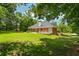 Brick home featuring a walkout basement, back deck and large backyard, offering seamless indoor-outdoor living at 40 Costleys Bridge Dr, Oxford, GA 30054