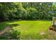 A spacious, grassy backyard that is perfect for outdoor activities and relaxation surrounded by mature trees at 40 Costleys Bridge Dr, Oxford, GA 30054