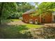 Back of brick house, featuring basement door and access to backyard, with ample green space and trees at 40 Costleys Bridge Dr, Oxford, GA 30054