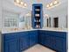 Stylish bathroom featuring dual sinks, ample counter space, and custom blue cabinetry at 40 Costleys Bridge Dr, Oxford, GA 30054