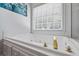 Inviting bathtub with jets offers relaxation and luxury, highlighted by a large window for natural light at 40 Costleys Bridge Dr, Oxford, GA 30054