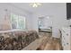 Cozy bedroom with a large bed, natural light, and mirrored closet doors at 40 Costleys Bridge Dr, Oxford, GA 30054