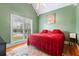 Cozy bedroom featuring a vaulted ceiling, large window, and warm green walls, creating a peaceful retreat at 40 Costleys Bridge Dr, Oxford, GA 30054
