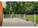 Exterior of house features a large deck surrounded by a white railing with plants and wooded area at 40 Costleys Bridge Dr, Oxford, GA 30054