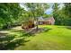 Beautiful red brick home with a lush green lawn and mature trees offering privacy and curb appeal at 40 Costleys Bridge Dr, Oxford, GA 30054