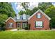 Charming one-story brick home featuring a beautifully landscaped front yard and traditional architectural details at 40 Costleys Bridge Dr, Oxford, GA 30054