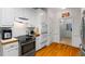 Well-lit kitchen with stainless appliances, white cabinetry, and hardwood floors at 40 Costleys Bridge Dr, Oxford, GA 30054