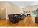 Spacious living room featuring hardwood floors, a fireplace, and large windows, creating a warm and inviting atmosphere at 40 Costleys Bridge Dr, Oxford, GA 30054