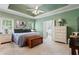 Serene main bedroom with a tray ceiling, natural light, and a calming color palette at 40 Costleys Bridge Dr, Oxford, GA 30054