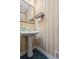 Charming powder room with a pedestal sink and stylish striped walls, adding character to the space at 40 Costleys Bridge Dr, Oxford, GA 30054