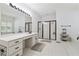 Large primary bathroom includes a shower with dark trim, soaking tub, and vanity area with drawers at 34 Johnston Nw Row, Cartersville, GA 30121