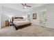 Spacious bedroom boasts a ceiling fan, neutral carpeting, and natural light from windows with plantation shutters at 34 Johnston Nw Row, Cartersville, GA 30121