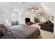 Expansive bedroom with multiple ceiling fans, a cozy sitting area, and plush carpets at 34 Johnston Nw Row, Cartersville, GA 30121